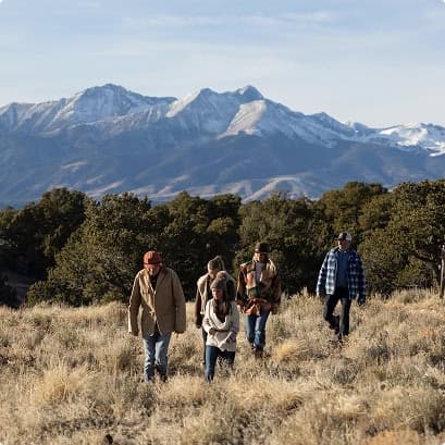 people on a hike with mountains behind them
