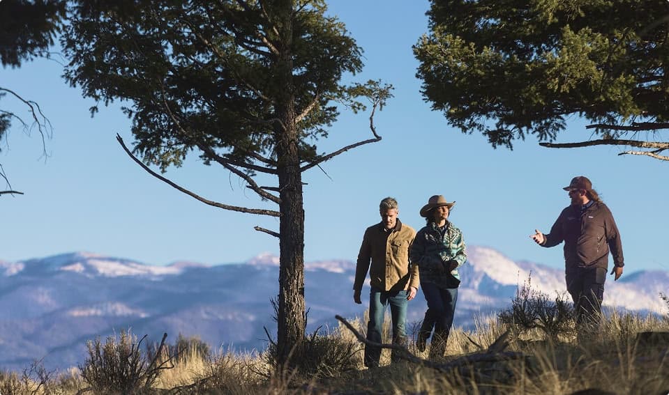 Small group hiking with a guide through a scenic mountain landscape.